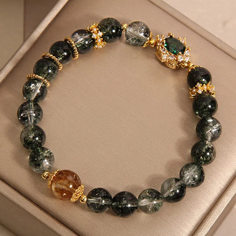 Gold rutilated quartz bracelet with green phantom quartz beads, gold ruby quartz accents, pearl and rhinestone details