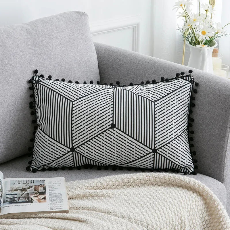 Bohemian national style throw pillow cushion cover in light grey on a sofa.