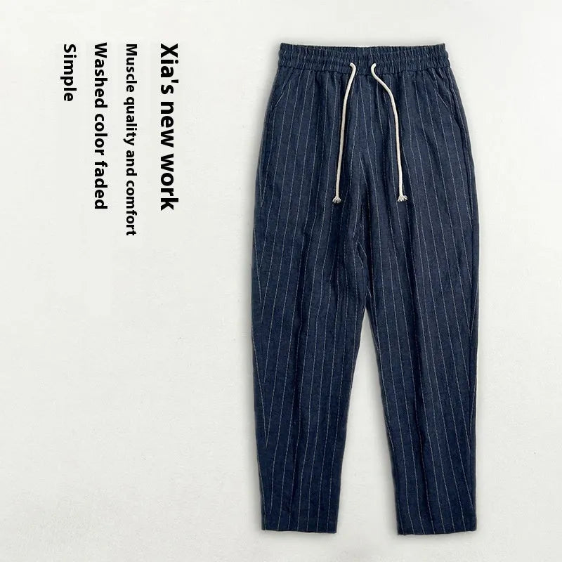 Man wearing beige striped cropped casual cotton-linen trousers on a summer day.