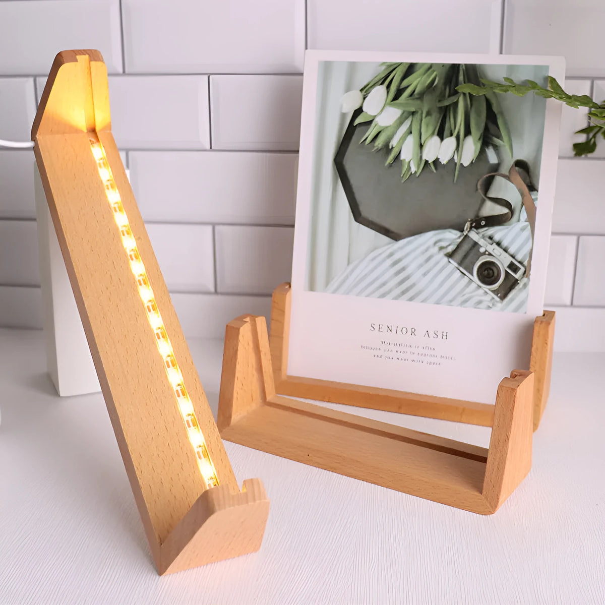 Wooden U-shaped luminous display stand with warm light holding a photo on a desk