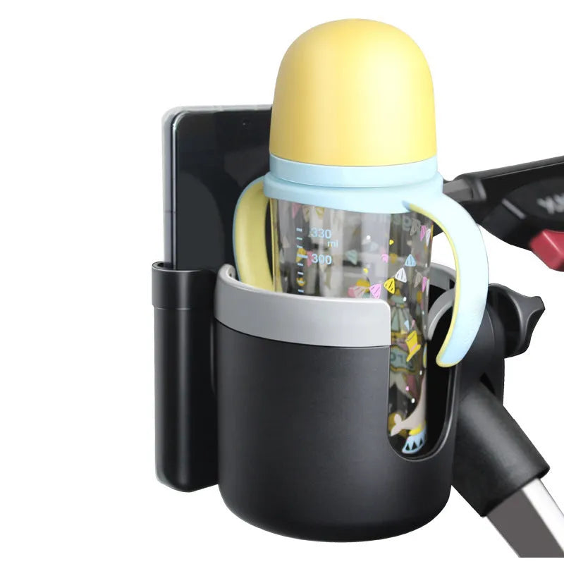 2-in-1 baby stroller cup holder in black silicone and ABS, clipped to pushchair frame, holding a drink
