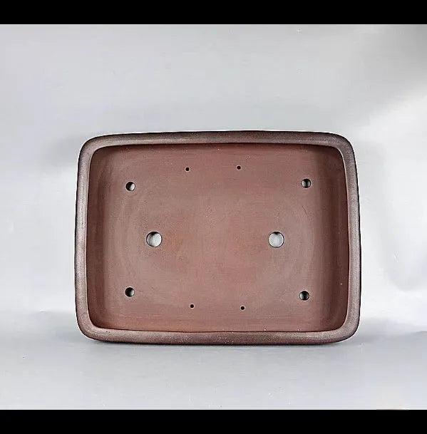 Large rectangular antique purple clay flower pot for indoor plants on a tabletop.