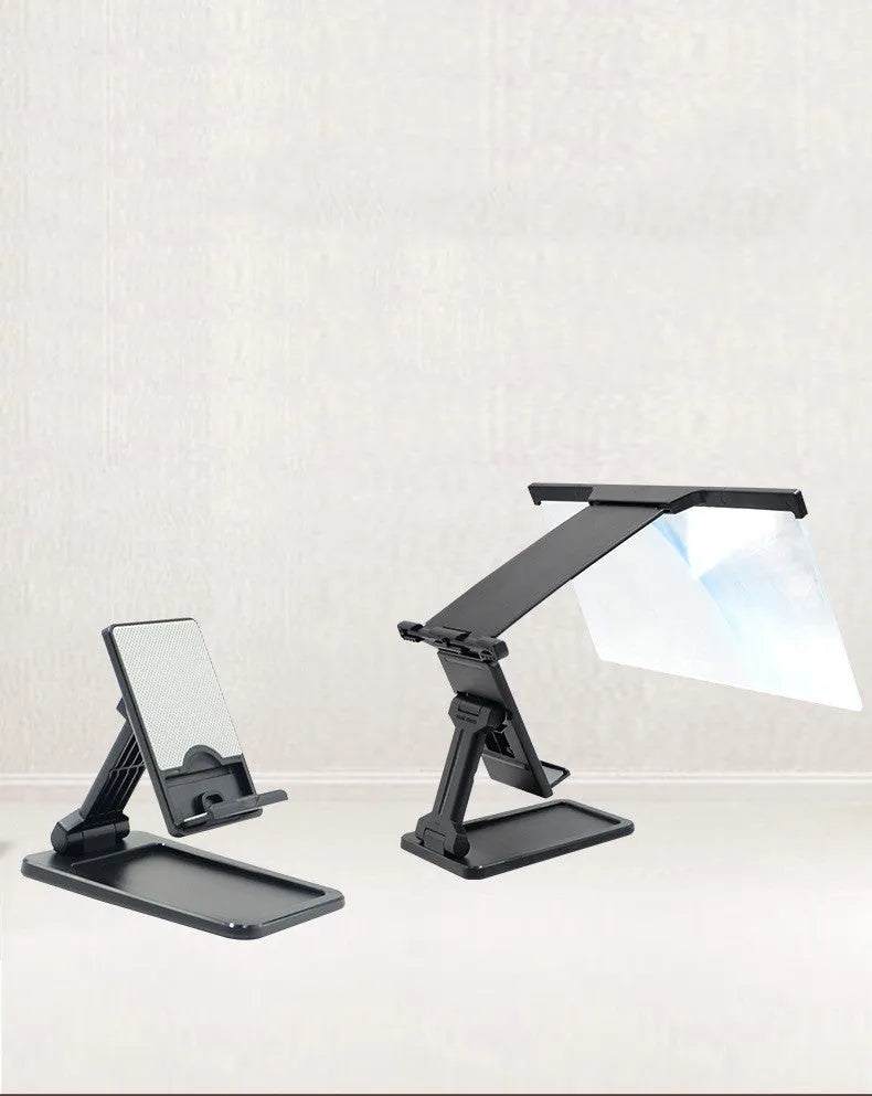 Black folding mobile phone screen magnifier with detachable holder on a desk.