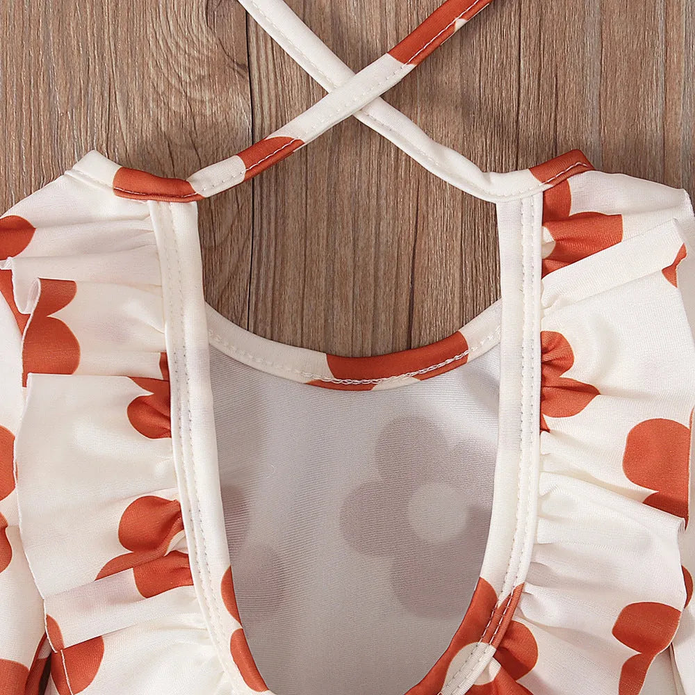 Girl's floral print swimsuit with crew neck and open back in orange red colour.