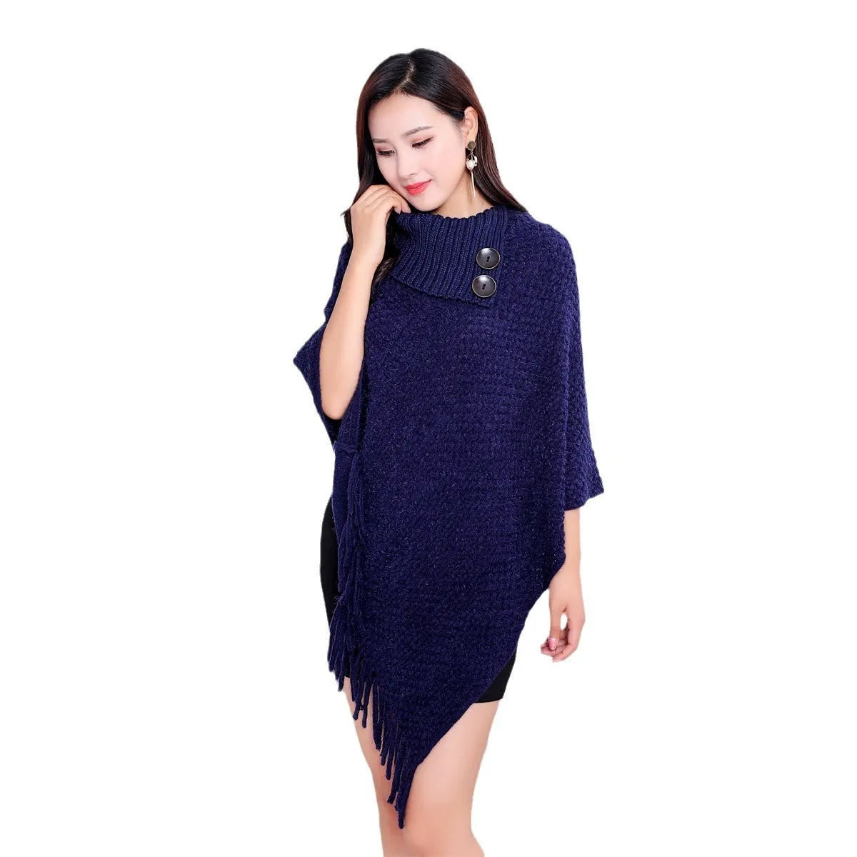 Dot-patterned acrylic knitted shawl cloak in apricot colour, laid flat.