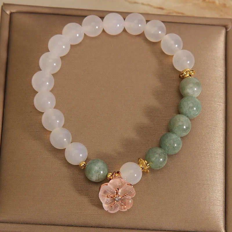 Jade floral bracelet with white agate jadeite stone and pink flower details on wrist