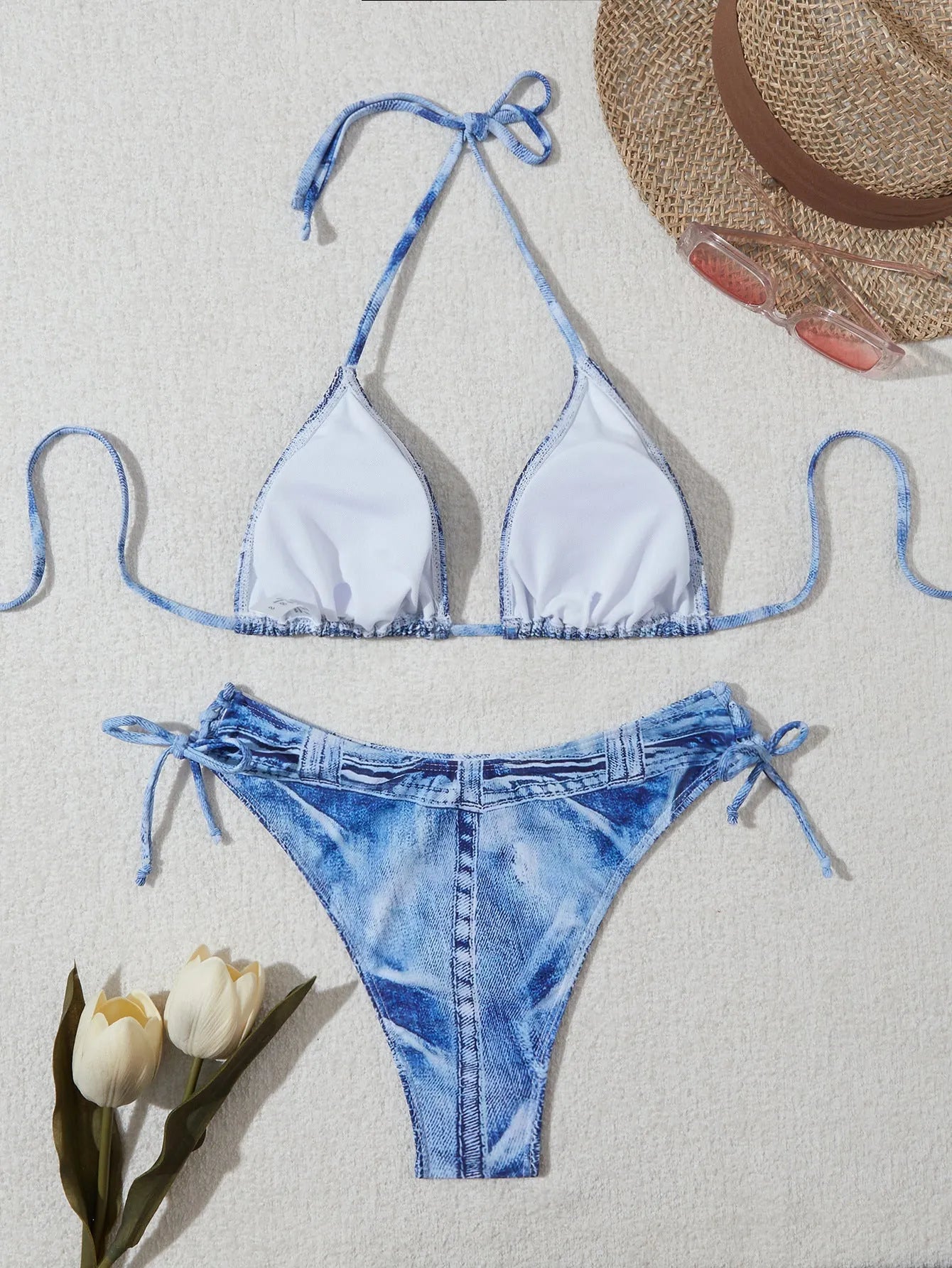 Denim blue printed women's bikini set with strap design on a mannequin, showing top and bottom.