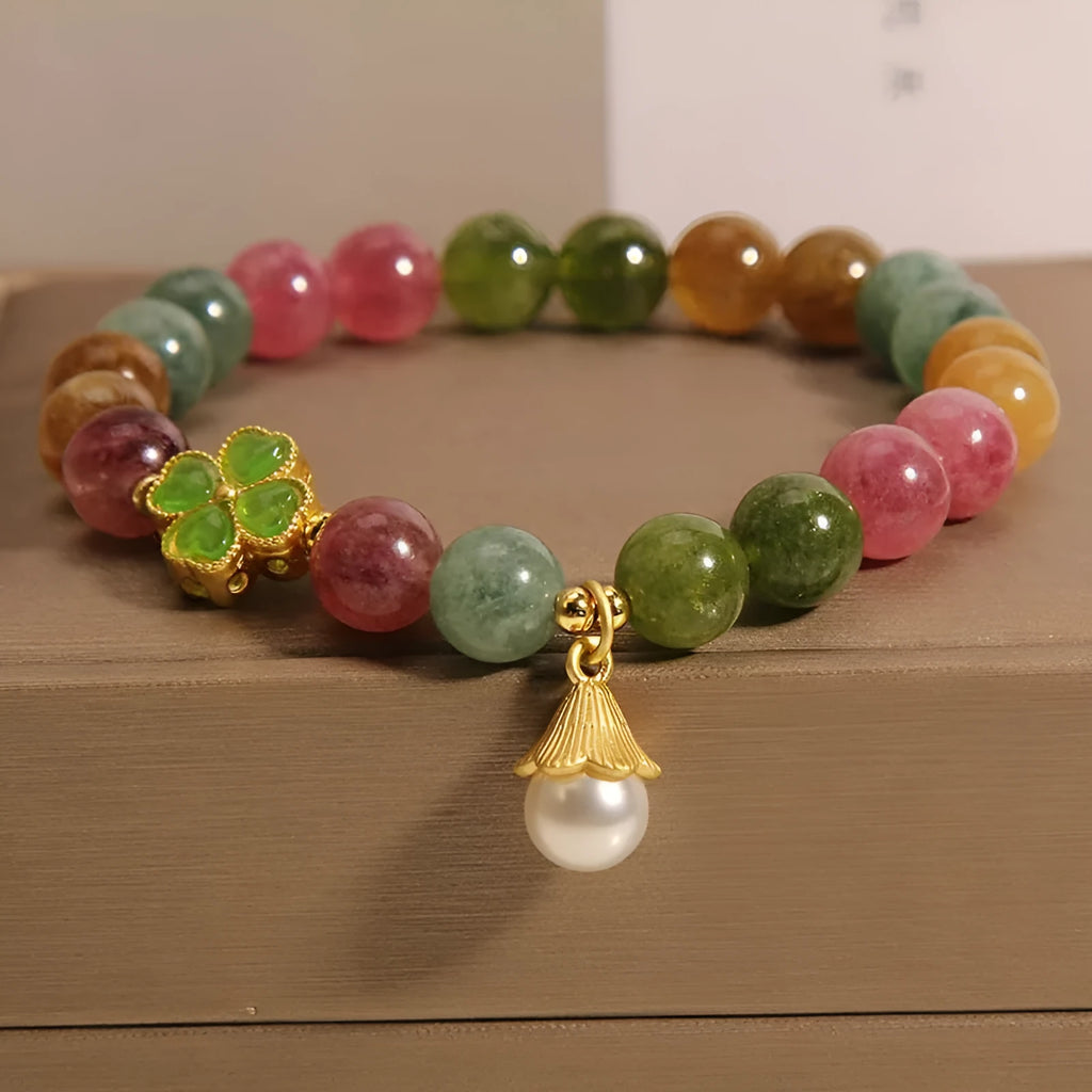 Women's colourful tourmaline bracelet with four-leaf clover charm and pearl pendant on a mixed material electroplated chain.
