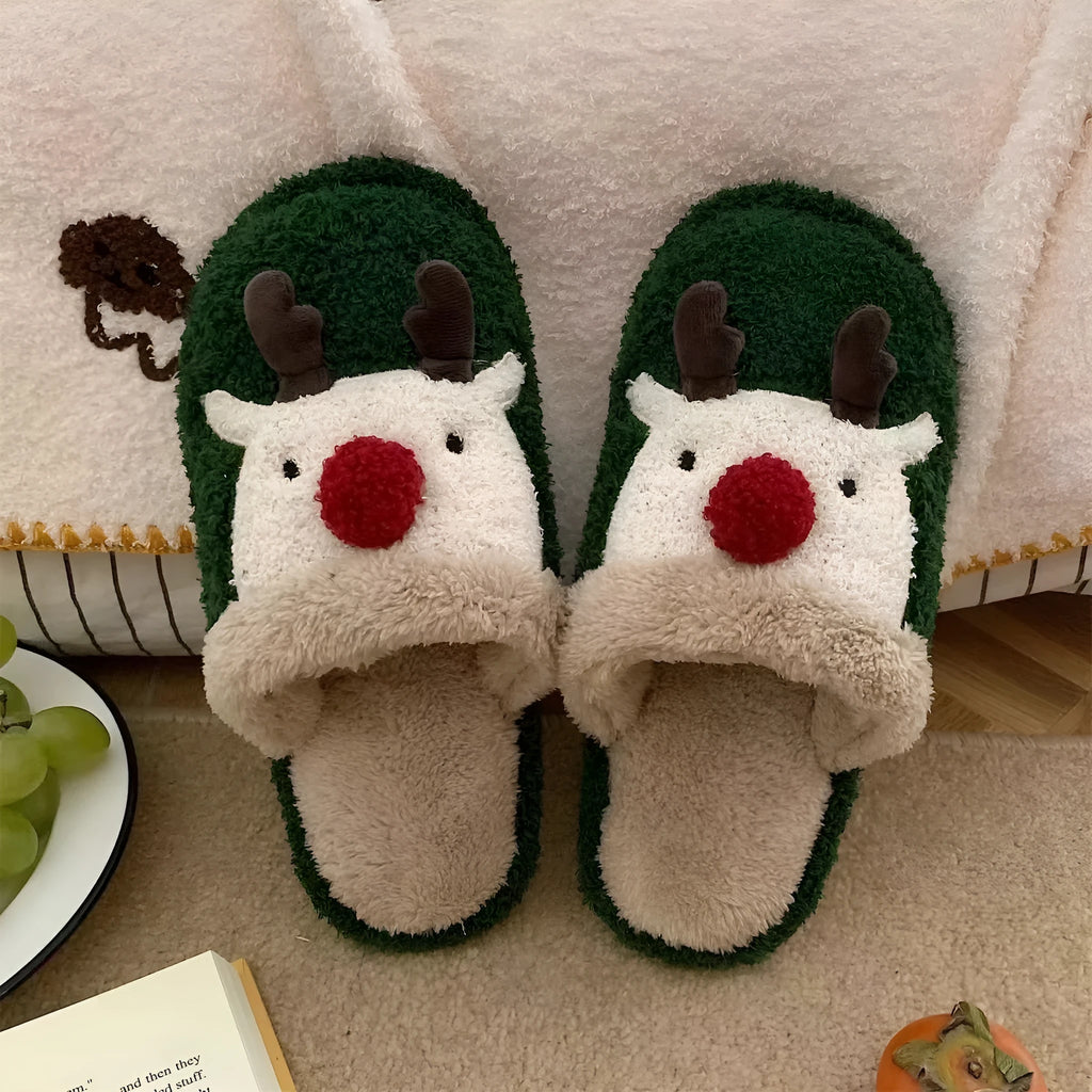 A pair of women's pink cotton slippers with a Christmas deer pattern and a white non-slip PVC sole.