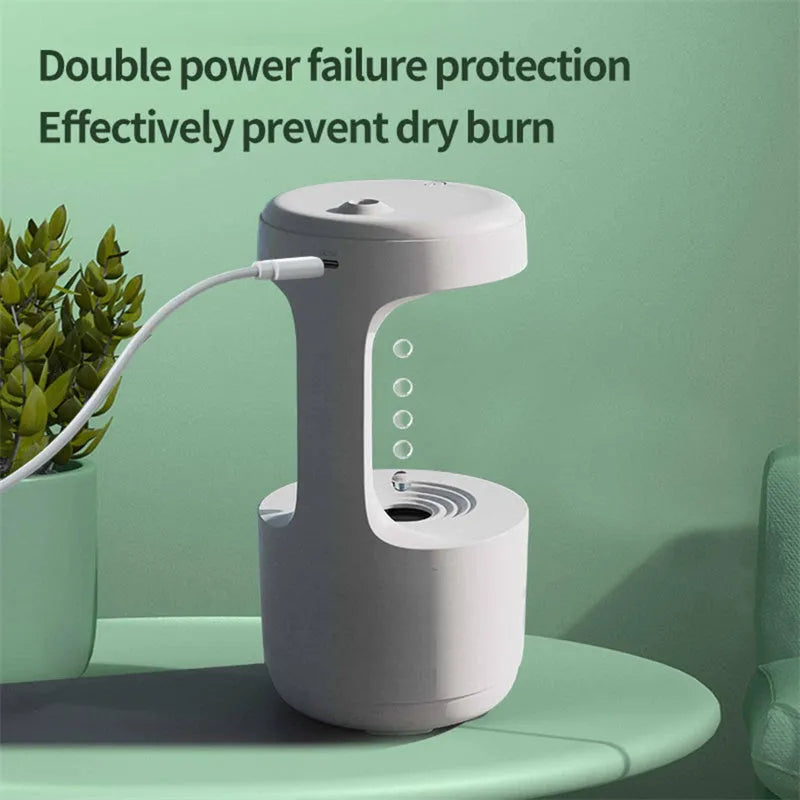 White columnar anti-gravity humidifier with LED clock display emitting mist on a wooden desk.