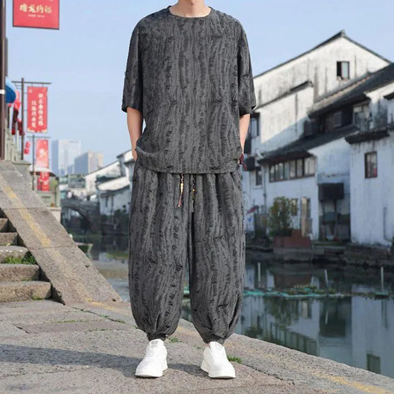 Men's thin black knitwear short-sleeve suit with cropped trousers on hanger