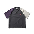 Dark grey men's loose fit t-shirt with contrasting raglan sleeves on a hanger.
