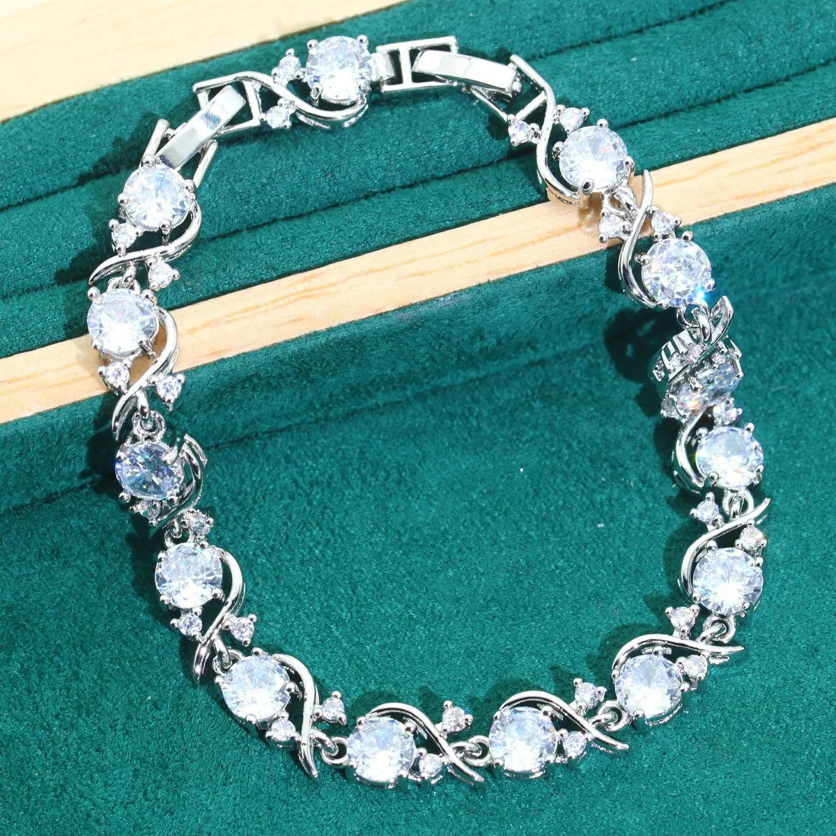 Four-piece bridal zircon jewellery set showing necklace, bracelet, earrings, and ring in a choice of colours.