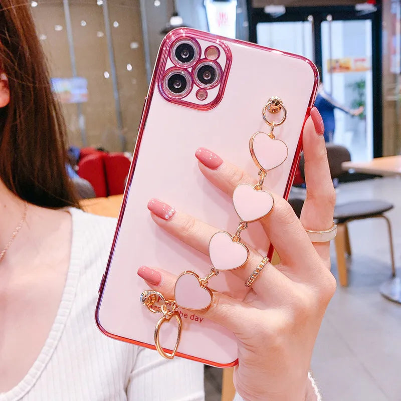 Green silicone Samsung phone case with an integrated fabric bracelet loop on the back.