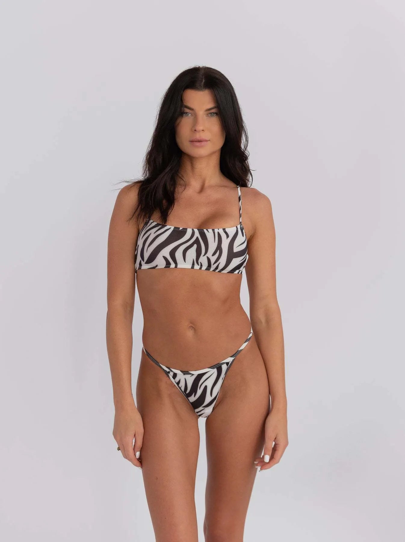 Women's striped bikini swimsuit with adjustable chest and pants straps.