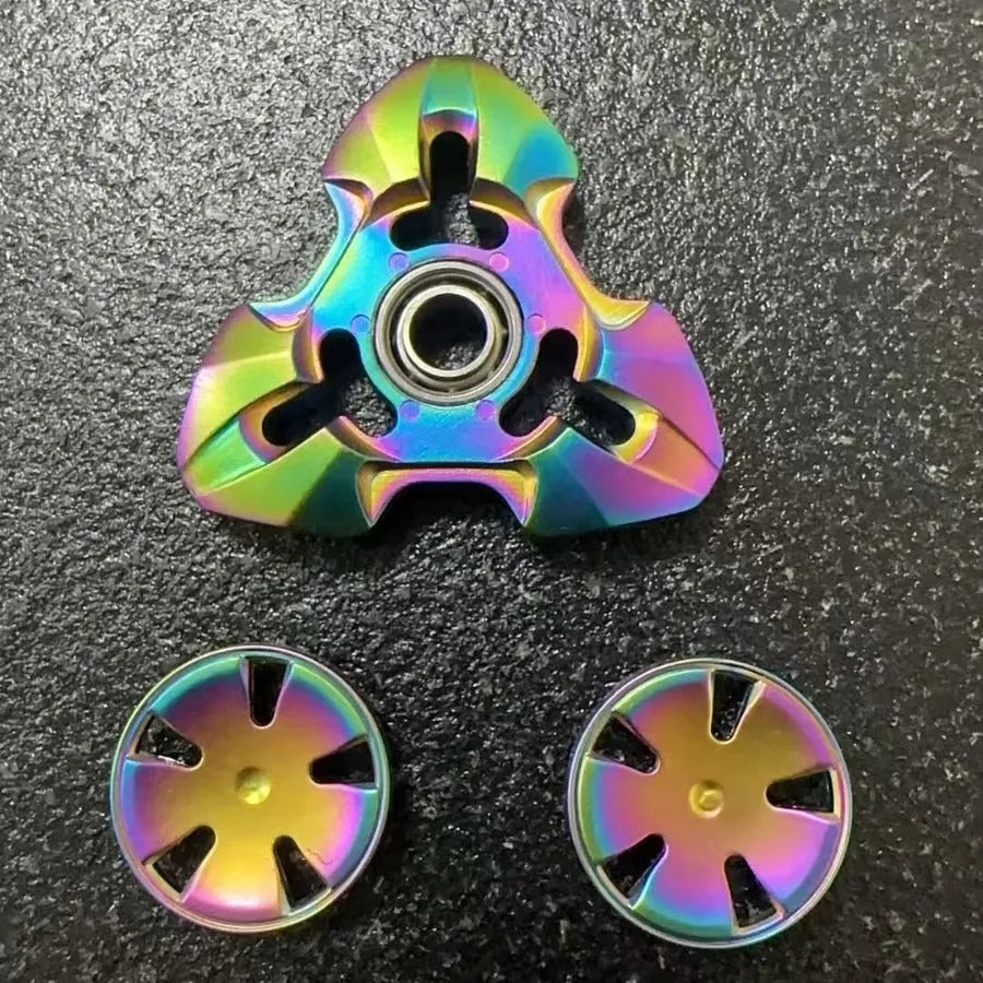 Metal alloy decompression toy with a rotating gyro, shown in gun colour and colourful options.