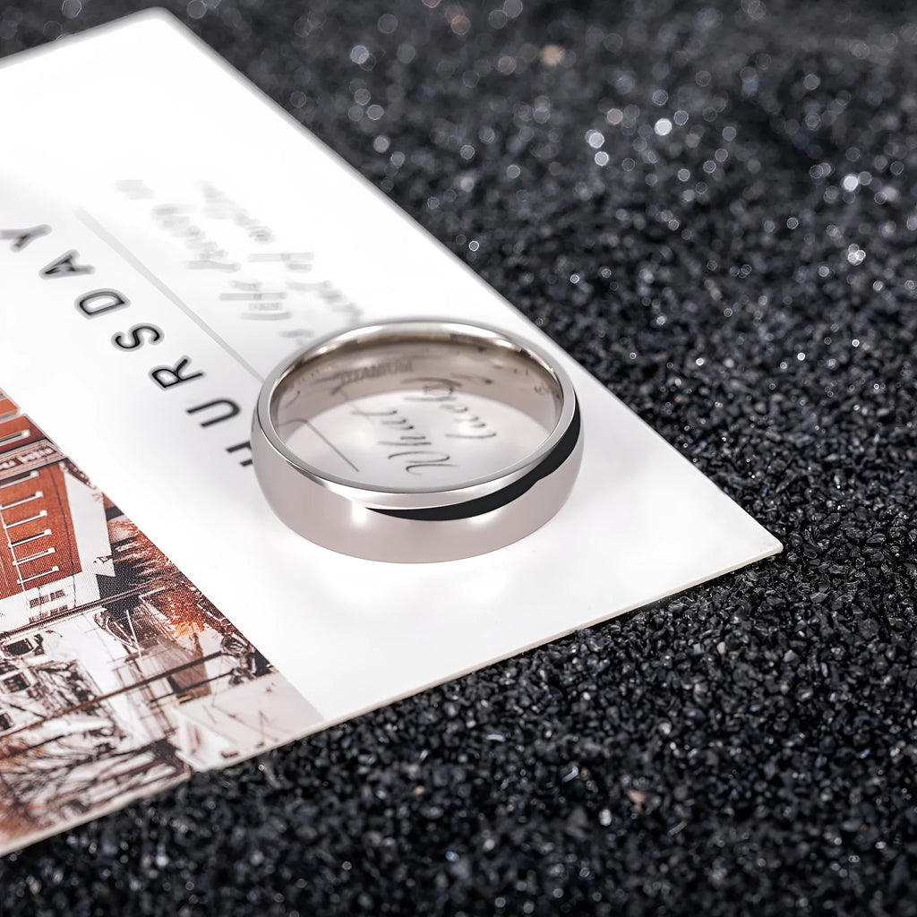 Silver titanium steel ring shown in a minimalist style on a finger, demonstrating its width options.