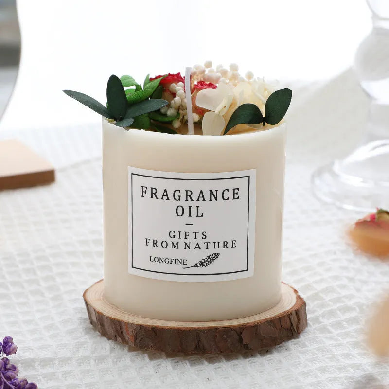 Decorative aromatherapy candle with dried flowers on surface, shown in gift box with chip base.