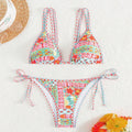 Women's lace-up split swimsuit in picture colour, showing backless design and adjustable ties.