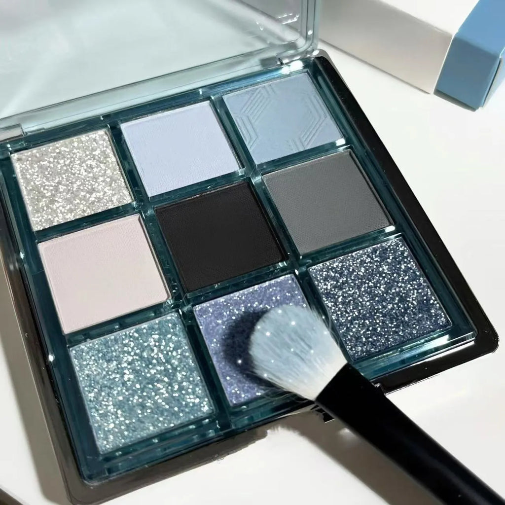 MUGELEEN nine-colour eyeshadow palette showing ice blue smoked shades and earth tone mattes