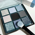 MUGELEEN nine-colour eyeshadow palette showing ice blue smoked shades and earth tone mattes