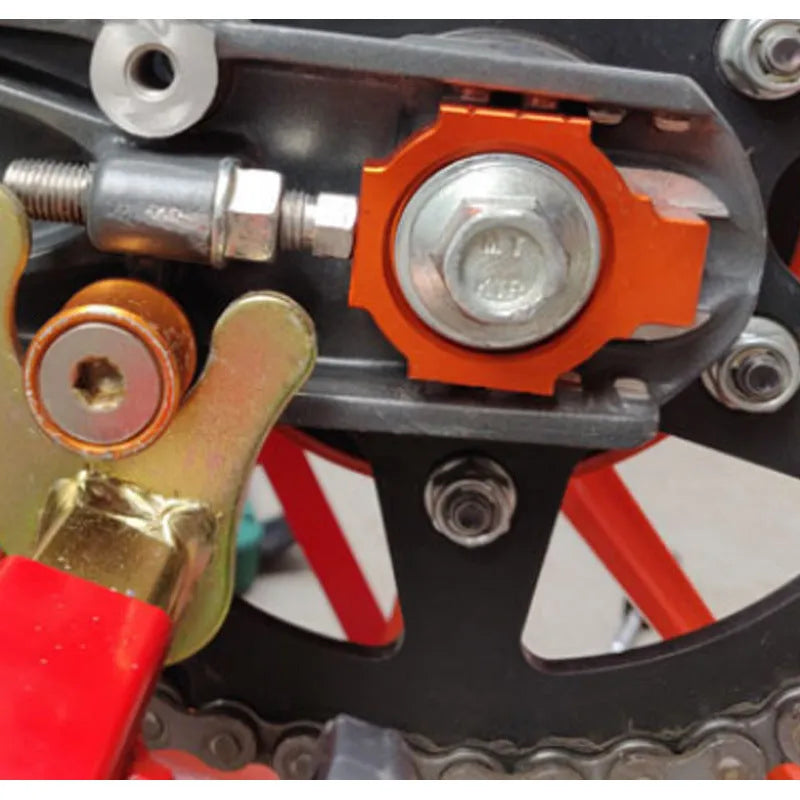 Orange anodised aluminium rear fork regulators for KTM Duke 200 390 990 motorcycles