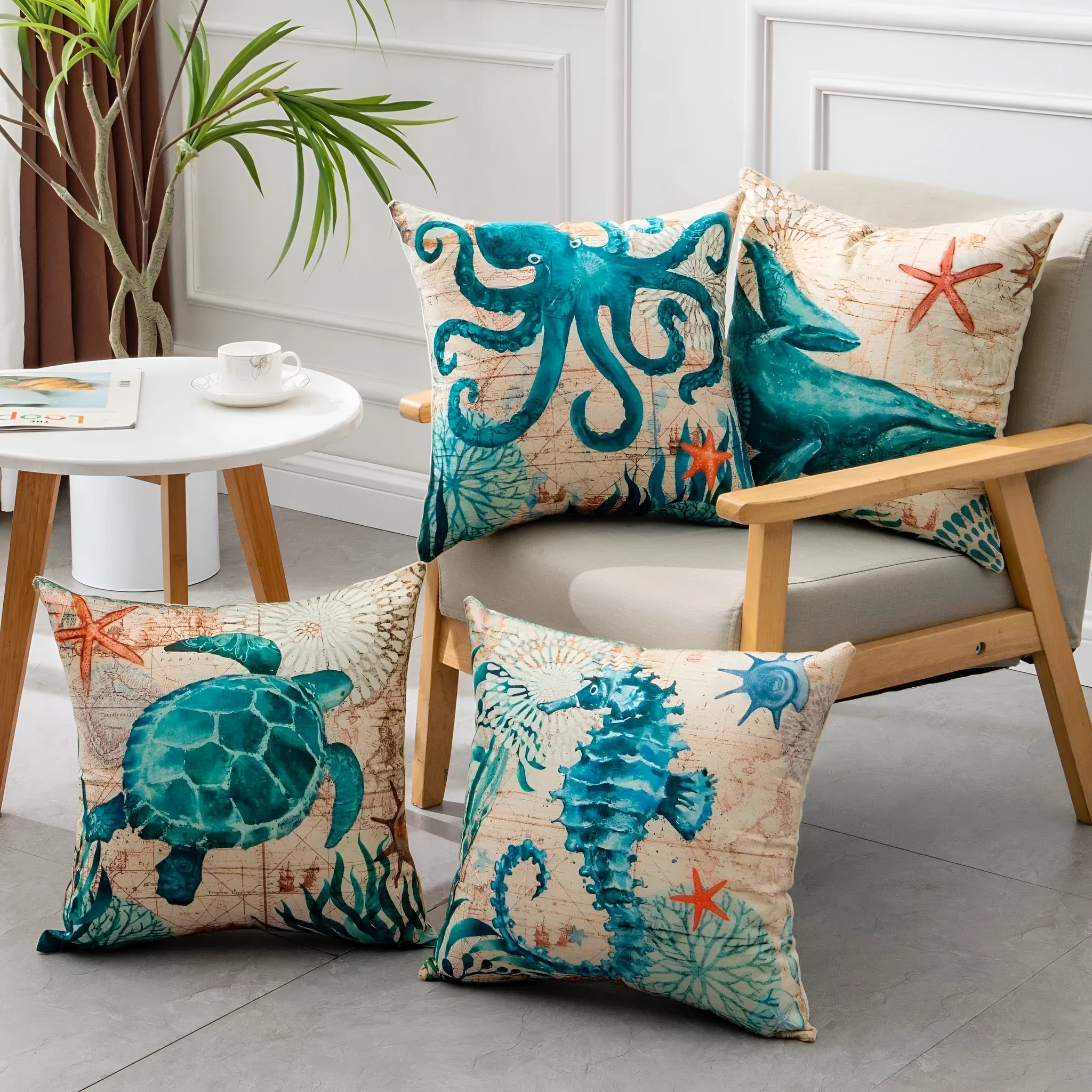 Square linen cushion cover with a detailed blue and green sea turtle print, shown on a grey sofa.