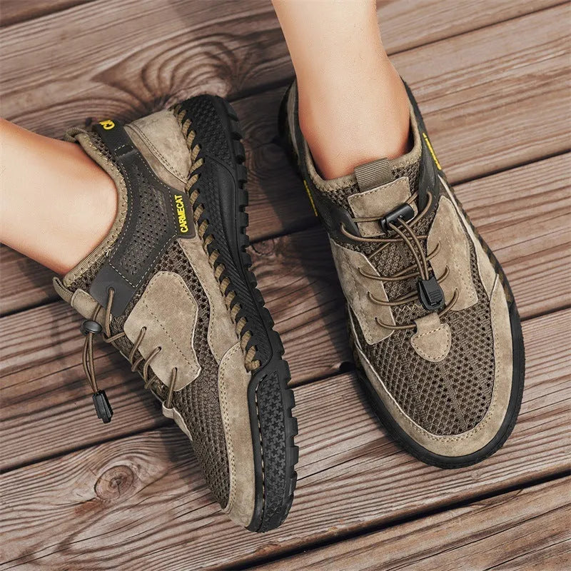 Men's grey suede low-top trainers with elastic band and hand-stitched rubber sole.