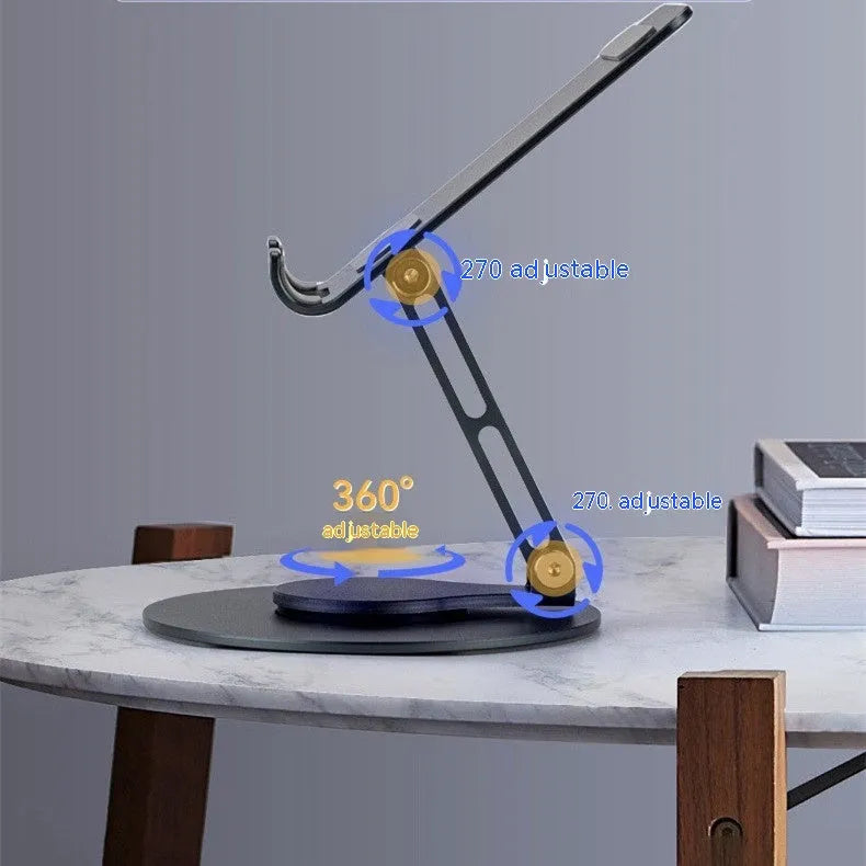 Grey aluminium alloy rotating mobile phone bracket on desk with silica gel grip, 4.8 x 4.2 x 1.4 cm, holding a smartphone in landscape mode