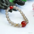 Smoky purple chalcedony red agate bracelet with 8mm geometric beads on a wrist.