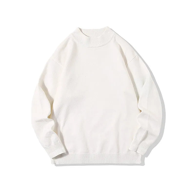 Man wearing a loose fit, solid colour round neck pullover sweater.