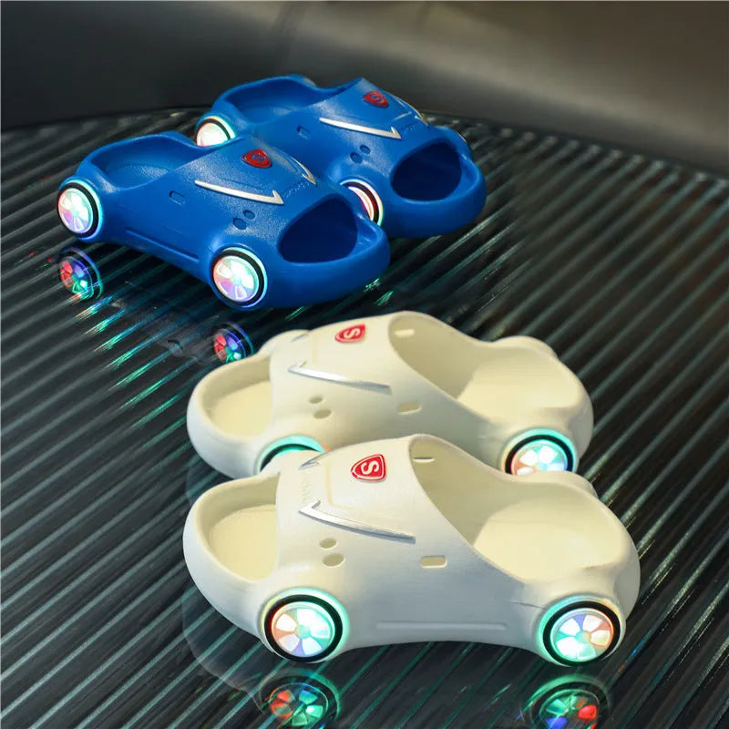 Children's luminous cartoon car slippers with anti-slip soles in blue, black, white, yellow, and pink colours.