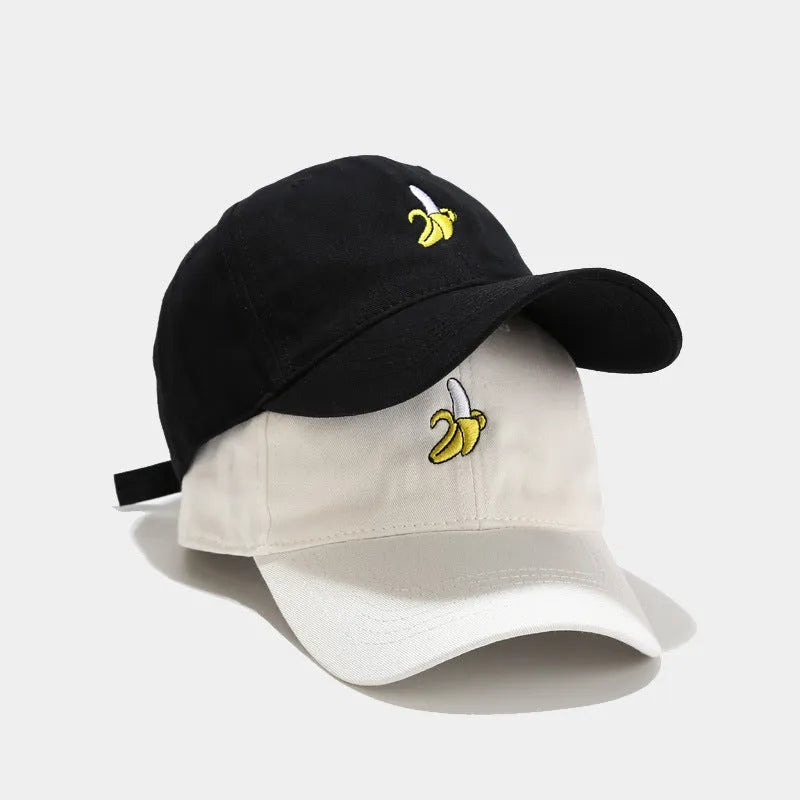 Adjustable banana-embroidered baseball cap in soft polyester fabric, shown in multiple colours.