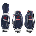 Dark blue pull rod golf bag with wheels and handle on a golf course