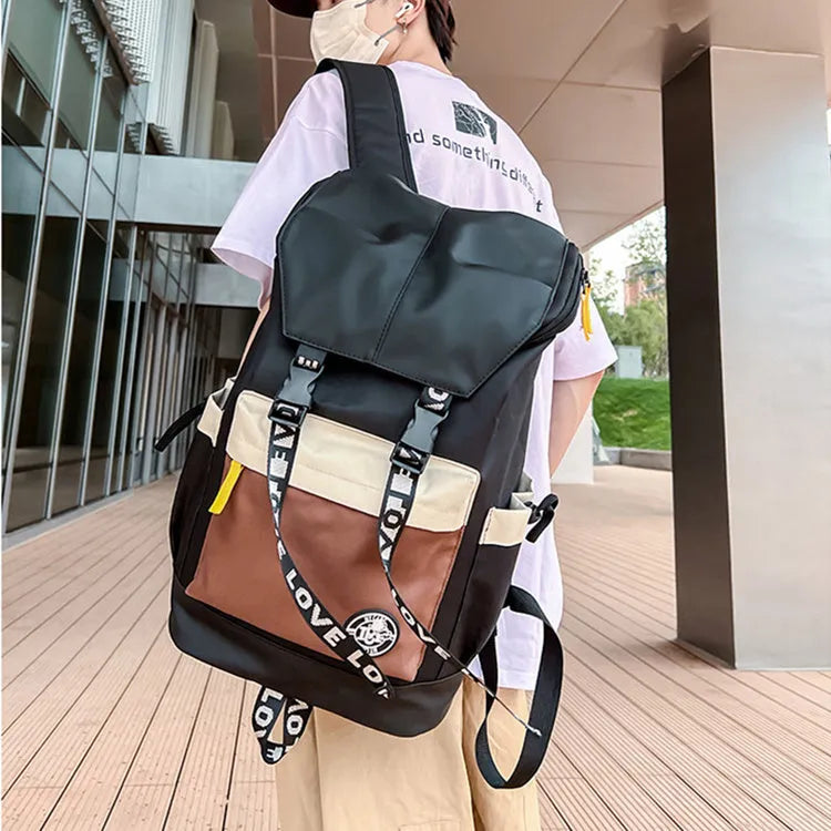 Oxford cloth student backpack in black, green, or red, showing handheld and shoulder straps.