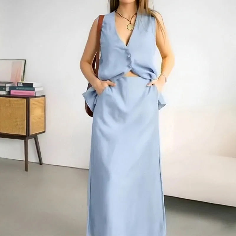 Women's blue sleeveless vest and long skirt two-piece casual co-ord set on a hanger.