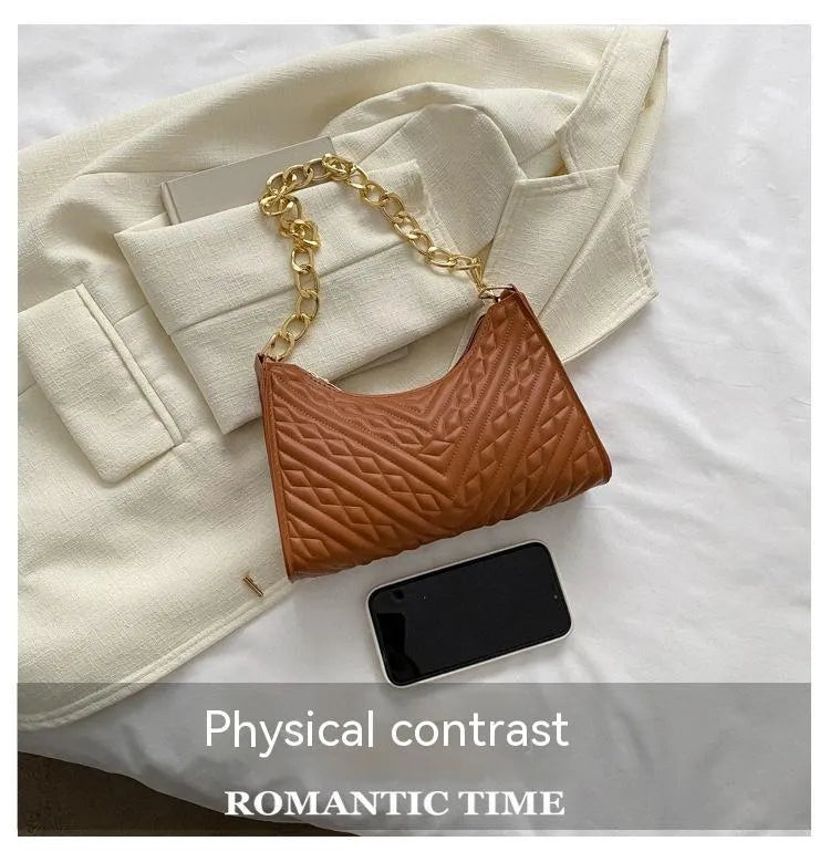 Brown pleated chain baguette shoulder bag showing vertical square shape and soft carry handle