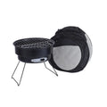 Small, round, folding metal ice stove grill with mesh top and legs, set up for outdoor use.