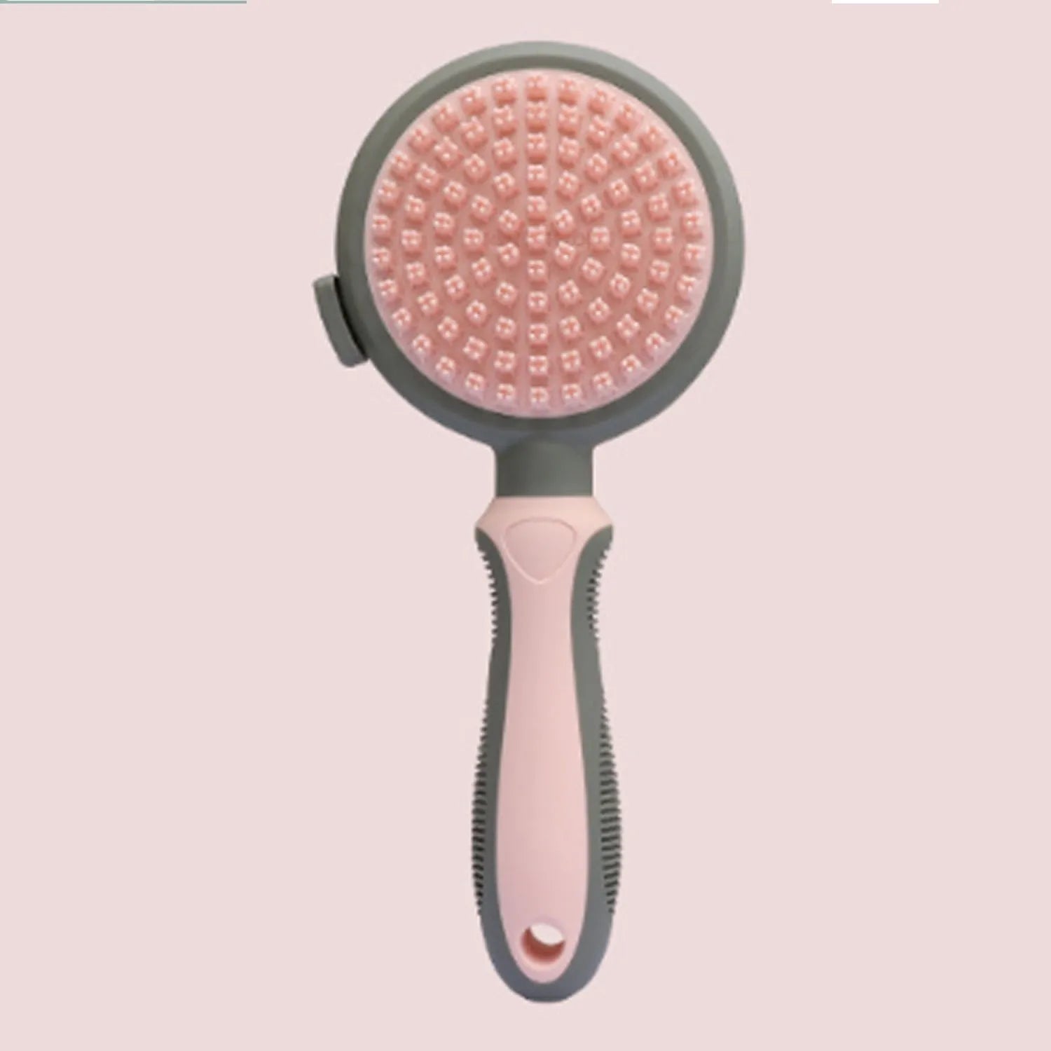 Pink and green double-sided cat grooming brush with release button and separate flea comb