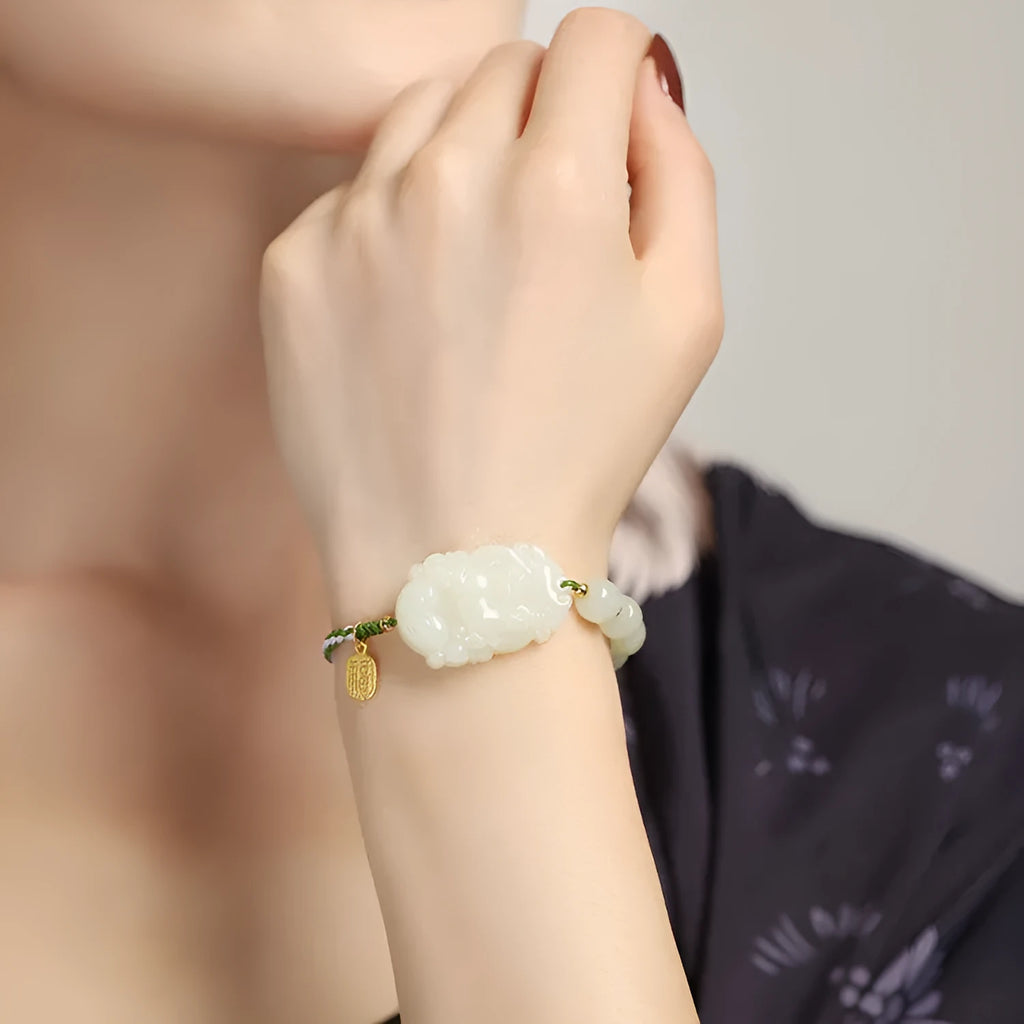 Rabbit Chinese zodiac bracelet with Hetian jade charm and silver card on a red rope.