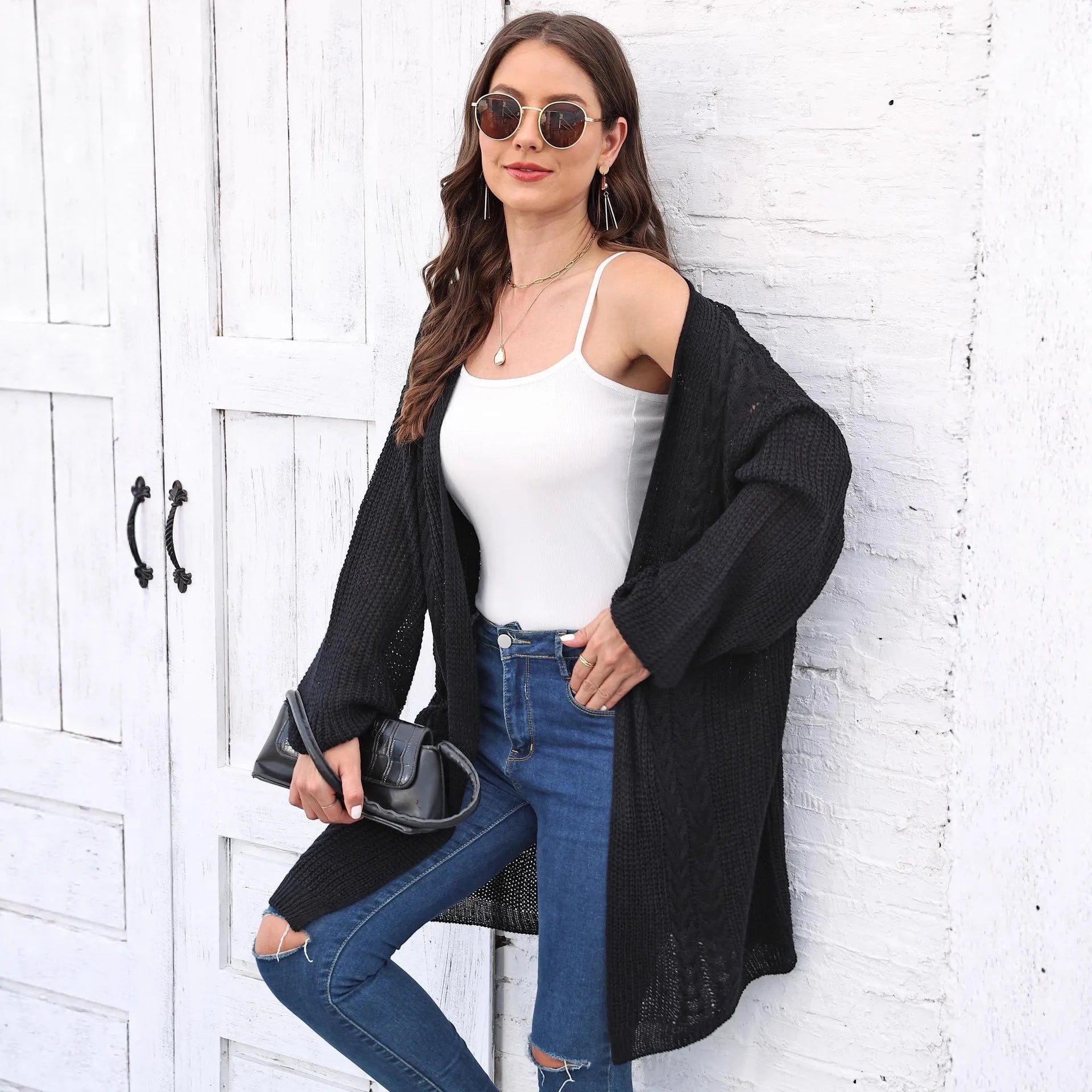 Women's loose-fit acrylic sweater coat in a solid colour, shown in light grey.