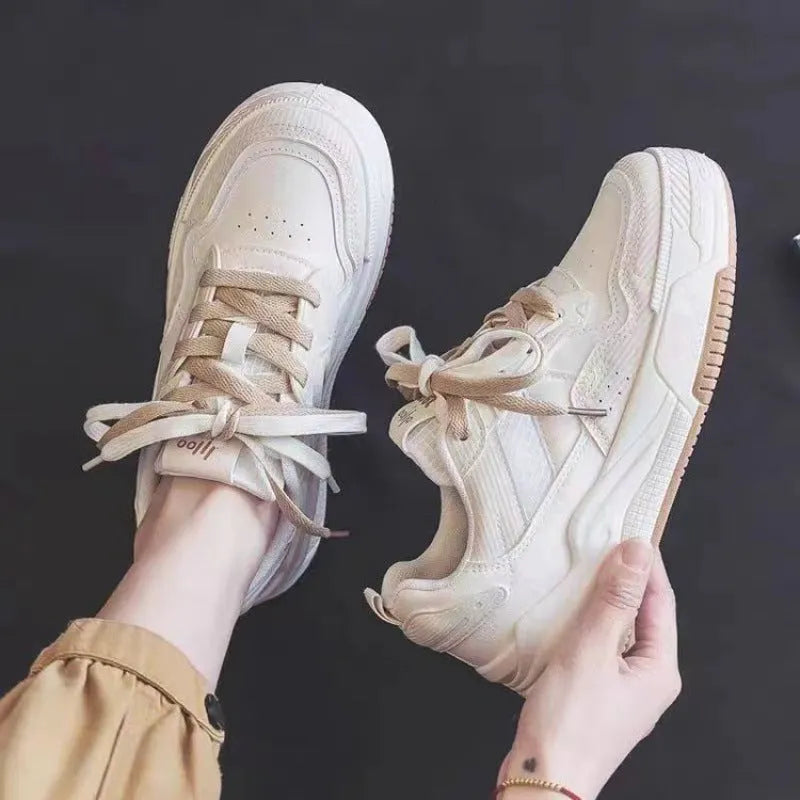 Women's beige and pink low-top rubber sole sneakers on a white background