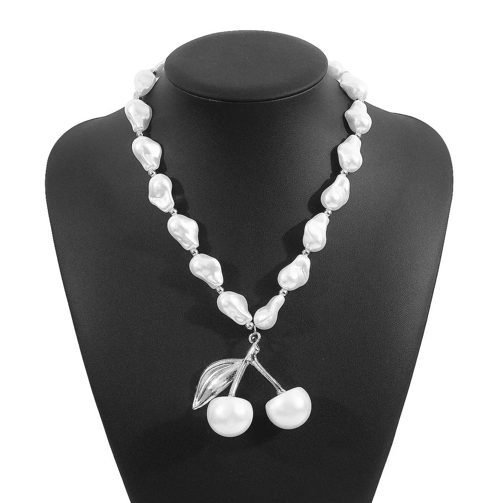 Women's gold and white necklace with cherry fruit and pearl pendant on an adjustable chain