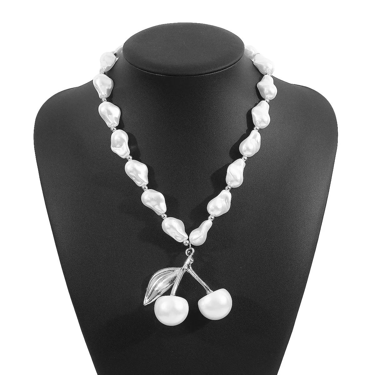 Women's gold and white necklace with cherry fruit and pearl pendant on an adjustable chain