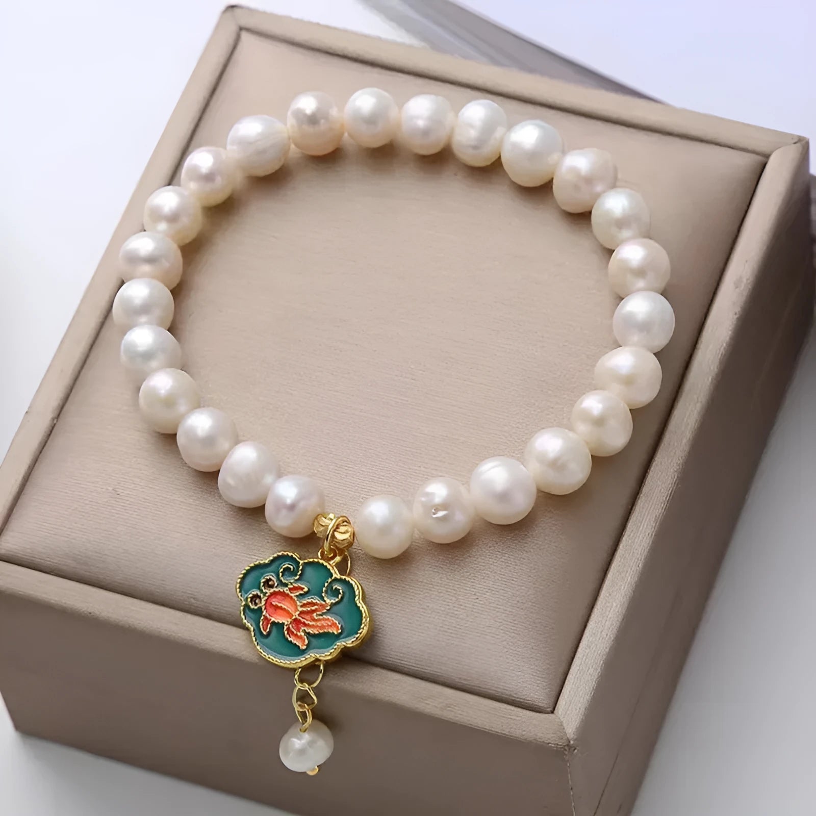 White antique freshwater pearl bracelet with a vintage goldfish and baroque lotus pendant on a chain.