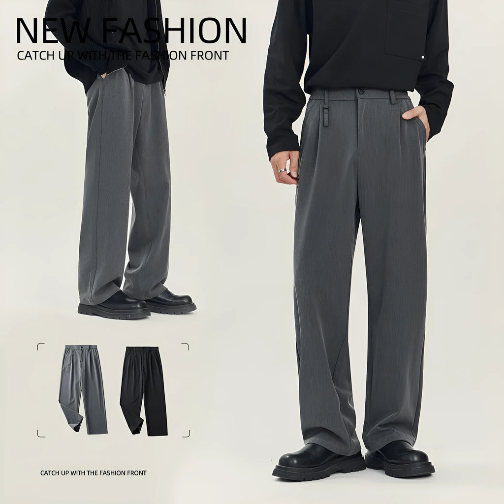 Man wearing black straight-leg business casual trousers with a draping design, made from a polyester blend fabric.
