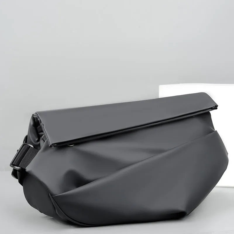 A grey medium-sized horizontal square PU crossbody bag for men, showing the shoulder strap and front zipper.