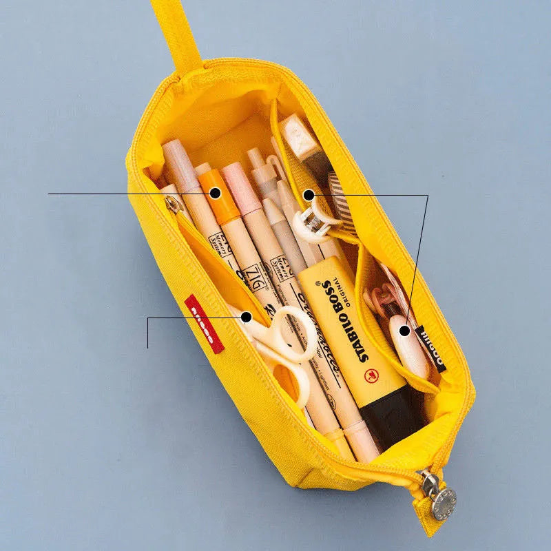 Large canvas pencil case with double zipper open, showing spacious interior for pens and pencils, in yellow colour.