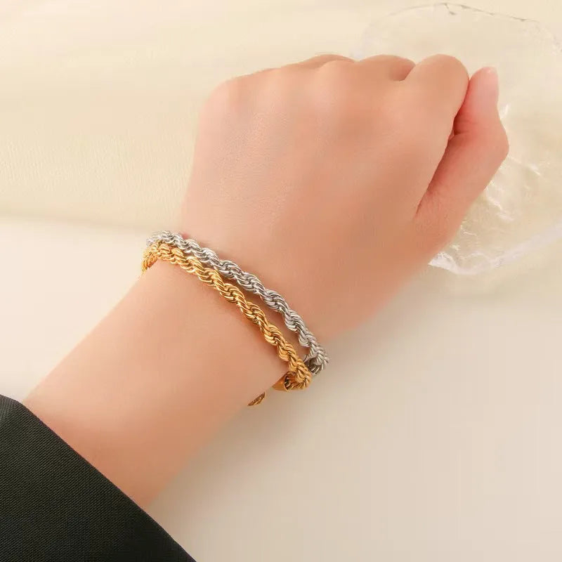 Alloy hip-hop twist bracelet for men in gold geometric chain style on a surface