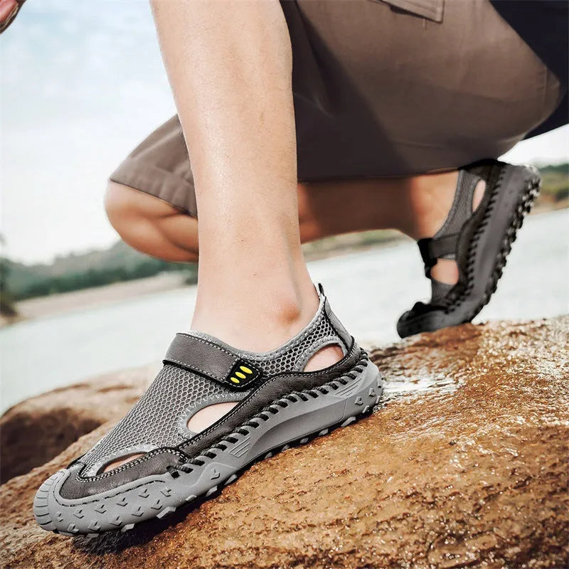 Men's black casual sandals showing breathable mesh upper and Velcro strap closure.